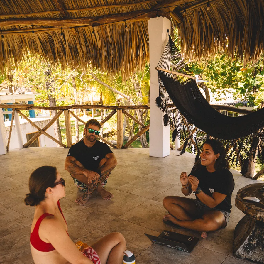 Guests resting under the palapa at the house between sessions